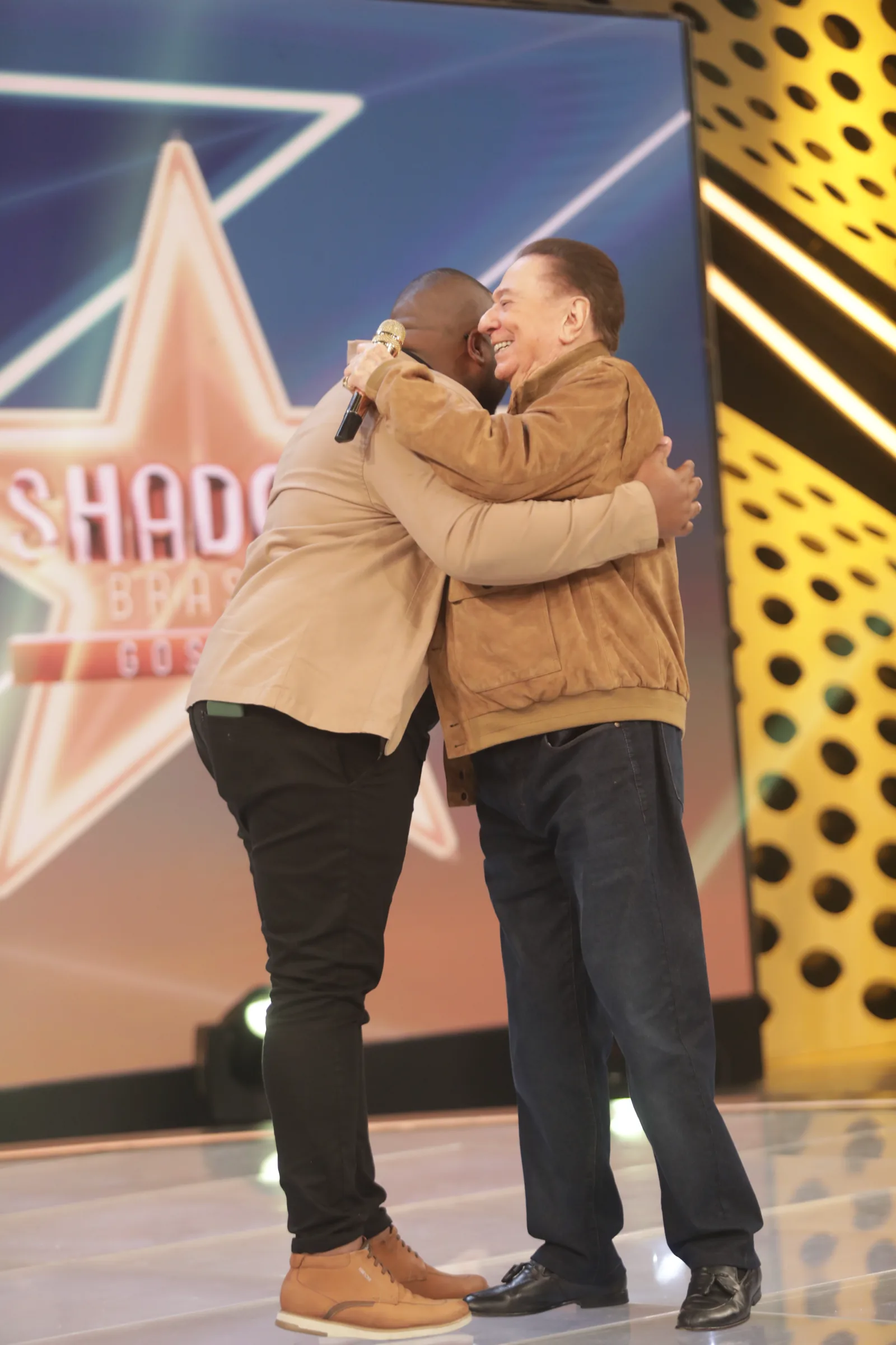 Kelvim e Raul Gil se abraçam no palco do Shadow Brasil Gospel